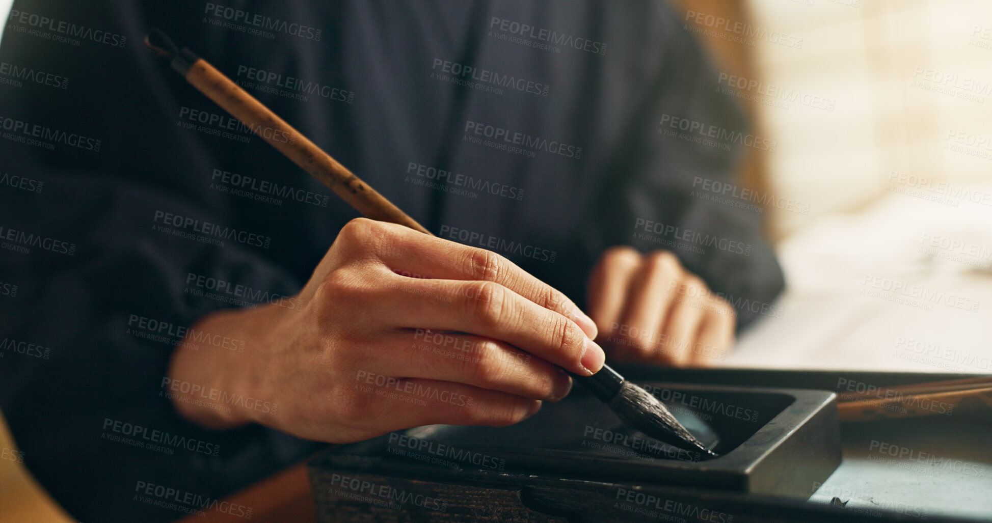 Buy stock photo Hands, reed pen or brush in ink for writing, calligraphy or ancient script for art and inkstone. Japanese creativity, black paint and vintage tools, paintbrush and stroke, traditional and stationery