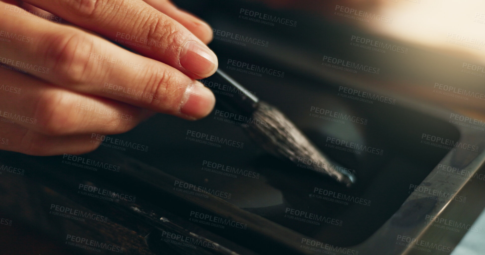 Buy stock photo Hand, closeup of brush in ink for writing and calligraphy or ancient stationery for art and inkstone. Japanese creativity, black paint with paintbrush and person stroke with traditional vintage tools