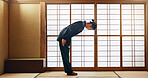 Bow, taekwondo or Asian man in dojo for martial arts for fitness, discipline or self defense for respect or honor. Kung fu master, workout or person in training for fighting, karate or combat sports