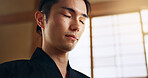 Thinking, zen and young Asian man with meditation, calm and relaxing face expression at home. Idea, mindfulness and male person with memory, reflection and breathing exercise in modern apartment.