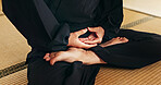 Martial arts person, meditation and floor with hands, feet and peace in dojo with spiritual guide for fight. Yoga, chakra balance and zen exercise for peace, calm or breathe for mma, karate or health