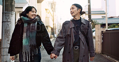 Buy stock photo Couple, smile and holding hands for walking in city, street and conversation with travel, vacation and care. Man, woman and together with chat, support and love on holiday on metro sidewalk in Tokyo