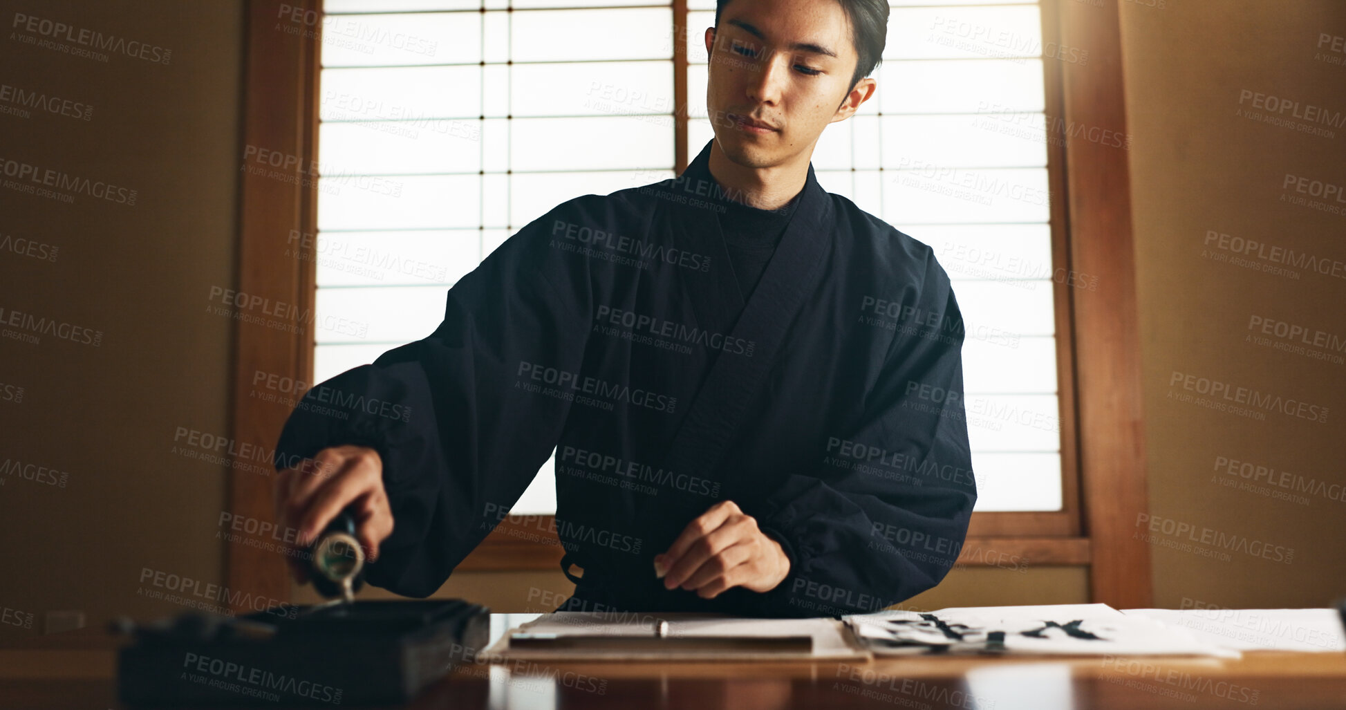 Buy stock photo Paper, ink and traditional Asian man for writing letters, notes and text for documents or script. Creative writer, culture and person with paint, tools and desk for art, calligraphy and handwriting