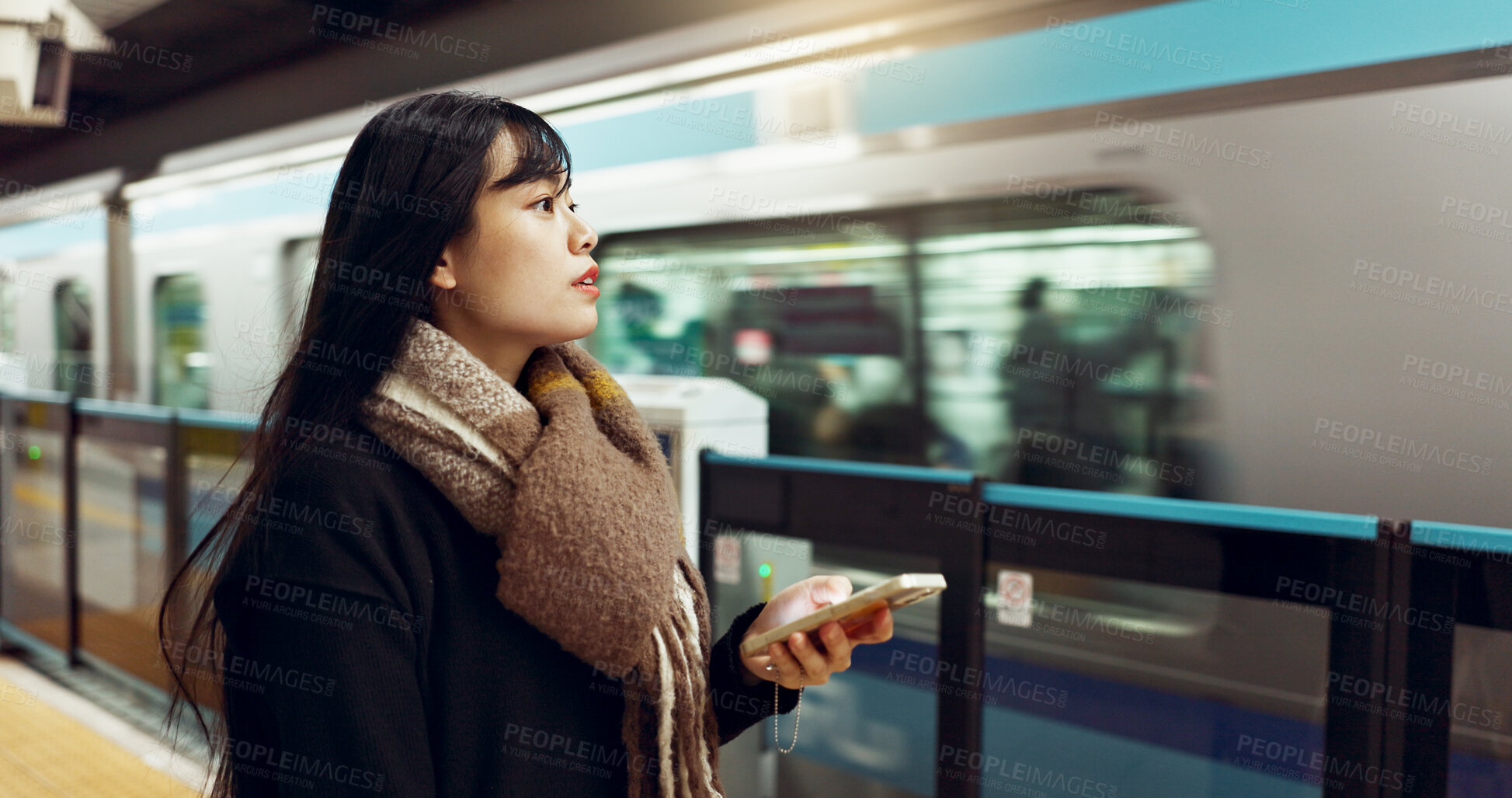 Buy stock photo Japanese woman, phone and train station for travel with app, waiting and happy for metro transportation. Girl, smartphone and happy for commute with locomotive for journey, adventure or web in Tokyo
