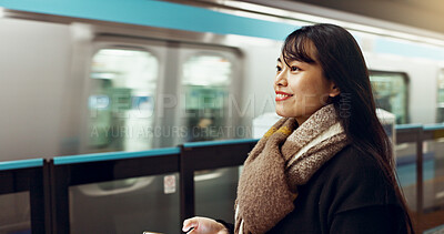 Buy stock photo Japanese woman, phone and train station for transport with app, waiting and happy for travel in metro. Girl, smartphone and smile for commute with locomotive for journey, social media or web in Tokyo