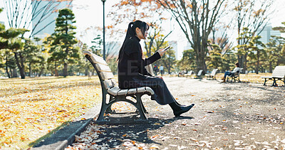 Buy stock photo Asian woman, walking and relax on park bench with phone for social media, communication or networking. Female person sitting with mobile smartphone for online search, streaming or break in nature