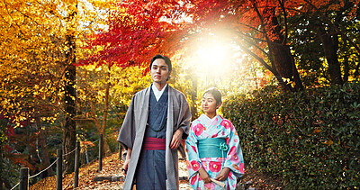Japanese people in park, walking and traditional clothes with path, nature and sunshine with respect and culture. Couple outdoor together in garden, date or commitment with love, bonding and calm