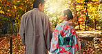 Man, woman and walking in forest with date in nature park, back of couple in traditional clothes in Japan. Love, care and together outdoor, peace and calm in garden with commitment, partner and trust