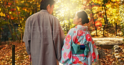Man, woman and walking in forest with date in nature park, back of couple in traditional clothes in Japan. Love, care and together outdoor, peace and calm in garden with commitment, partner and trust