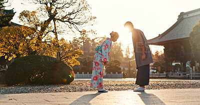 Japanese people at temple, bow and traditional clothes with hello, nature and sunshine with respect and culture. Couple outdoor, greeting with modesty and tradition, polite and kind for religion