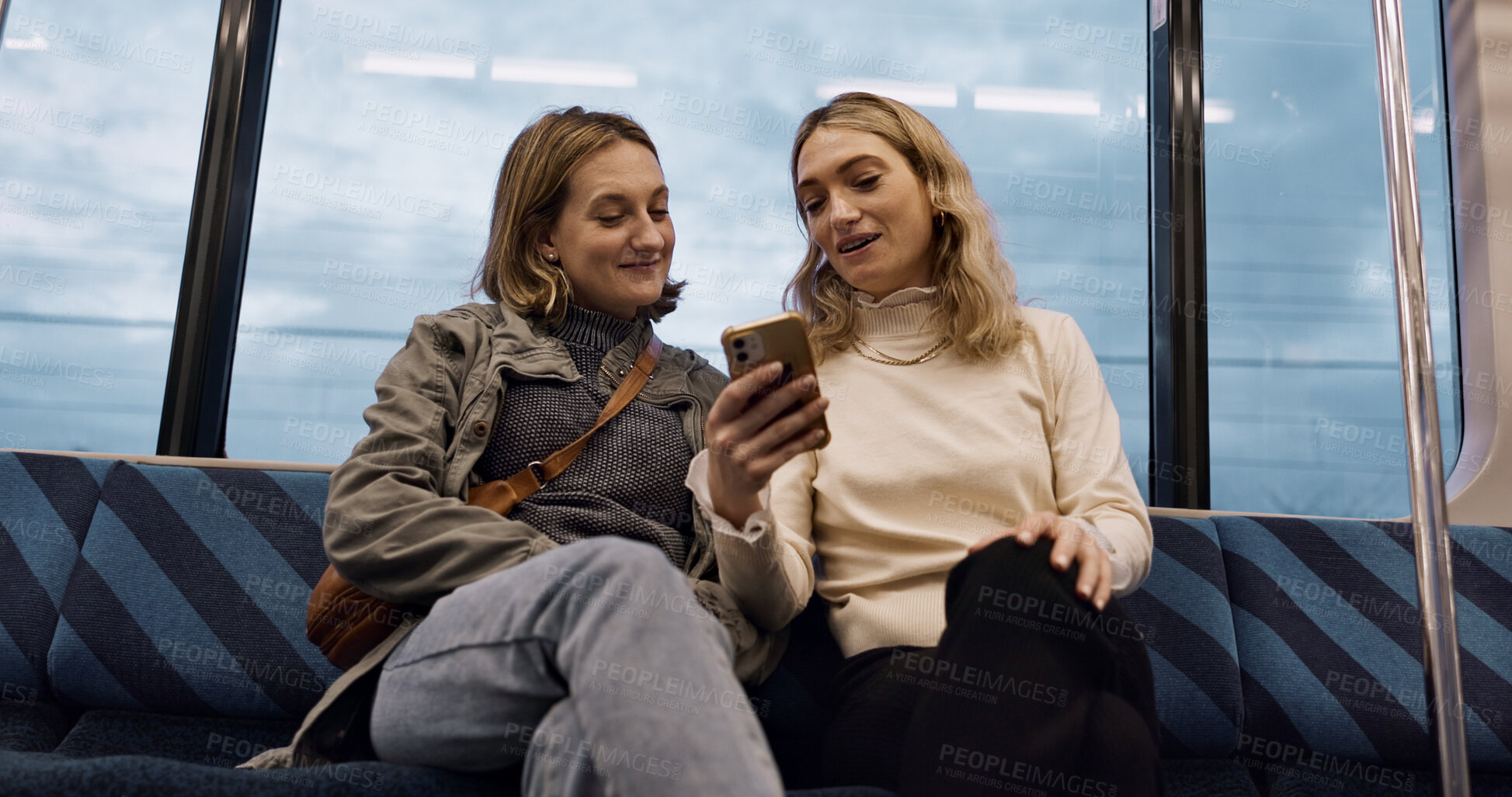Buy stock photo Happy woman, friends and phone on train for social media, communication or networking in public transport. Female person or people talking with mobile smartphone for online search on railway ride