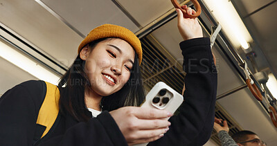 Japanese woman, phone and texting in train, smile and travel with click, press and check schedule on app. Girl, person and smartphone with chat, reading blog and social network with public transport