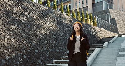 Japanese woman, student and walking with backpack, smile and commute at campus for education in Tokyo. Girl, person and outdoor at college for learning, development and happy on stairs with thinking