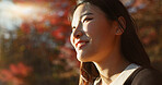 Outdoor, thinking and Asian woman with a smile, nature and forest with joy, daydreaming and holiday. Japanese person sunshine or girl with summer, travel or peace with vacation. calm or weekend break
