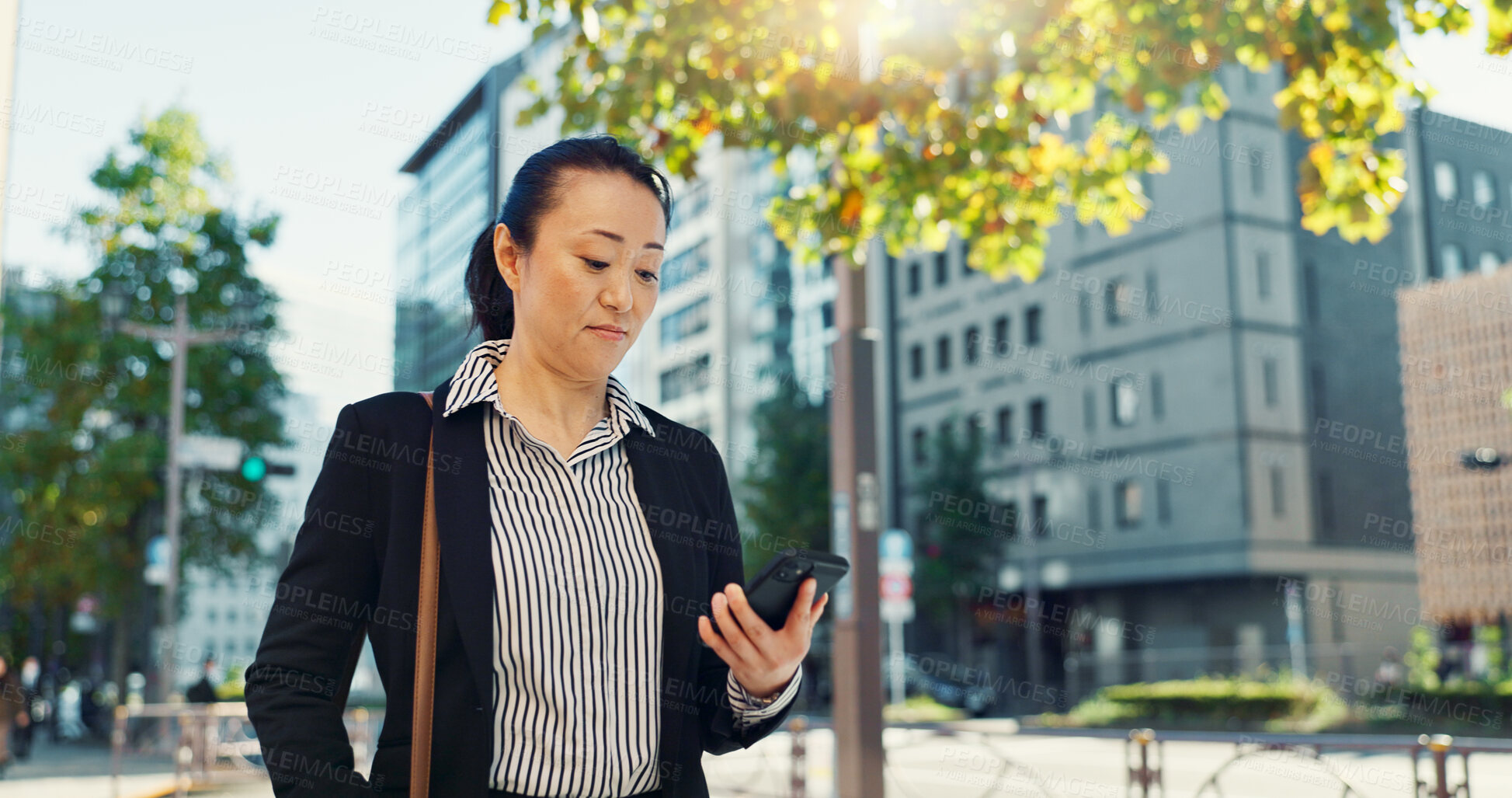 Buy stock photo Cellphone, walking and business woman in the city networking on social media, mobile app or internet. Technology, street and professional Asian female person with phone commuting in street in town.
