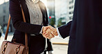 Business people, handshake and city for greeting, partnership or agreement in outdoor deal or meeting. Closeup of employees shaking hands outside for b2b, teamwork or hiring in an urban town together