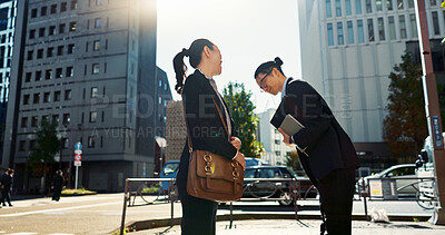 Asian people in city, professional and bow for greeting with conversation, travel and commute to work in morning. Business man, woman and hello in Tokyo, journey and urban street with communication