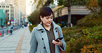 Phone, walking and business woman in the city networking on social media, mobile app or internet. Technology, street and professional Asian female person with cellphone commuting in street in town.
