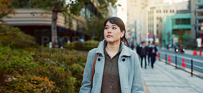 Woman, Asian and walking, travel or commute to work with professional in city with earphones. Listening to music on journey, podcast and commuter on urban street or sidewalk in Tokyo with playlist