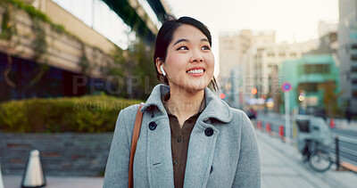 Woman, Asian and walk on sidewalk, travel or commute to work with professional in city with earphones. Listening to music on journey, podcast and commuter on urban street in Tokyo with playlist