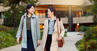 Walking, conversation and business women in the city talking for communication or bonding. Smile, discussion and professional Asian female people speaking and laughing together commuting in town.