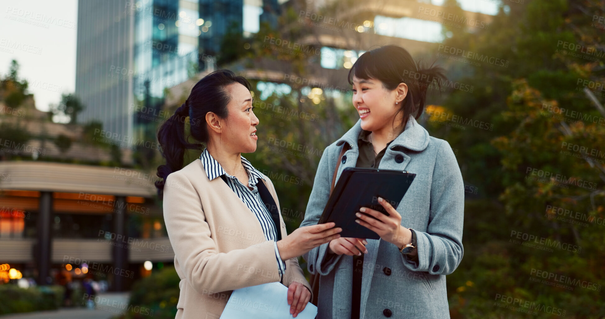 Buy stock photo Tablet, conversation and business women in the city talking for communication or bonding. Smile, discussion and professional Asian female people speaking with digital technology together in town.