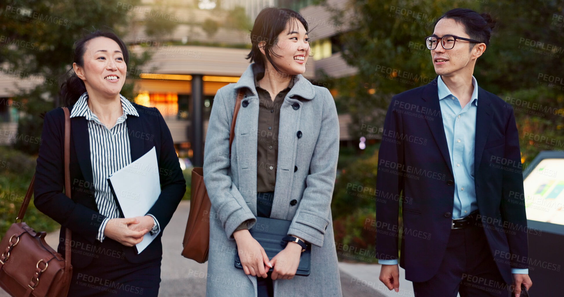 Buy stock photo Walking, conversation and business people in the city talking for communication or bonding. Smile, discussion and professional Asian colleagues speaking and laughing together commuting in town.