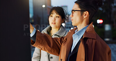 Conversation, night and young Asian couple in the city for travel, adventure or journey together. Communication, happy and man and woman talking by board for commuting in urban town in evening.