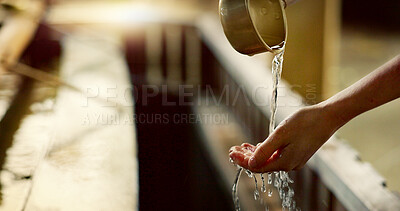 Shinto temple, closeup and washing hands with water in container for cleaning, faith and wellness. Religion, mindfulness and purification ritual to stop evil, bacteria and peace at shrine in Tokyo