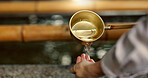 Temple, closeup and person washing hands in water, container and clean with faith for wellness. Religion, mindfulness and Shinto purification ritual to stop evil, bacteria or peace at shrine in Tokyo