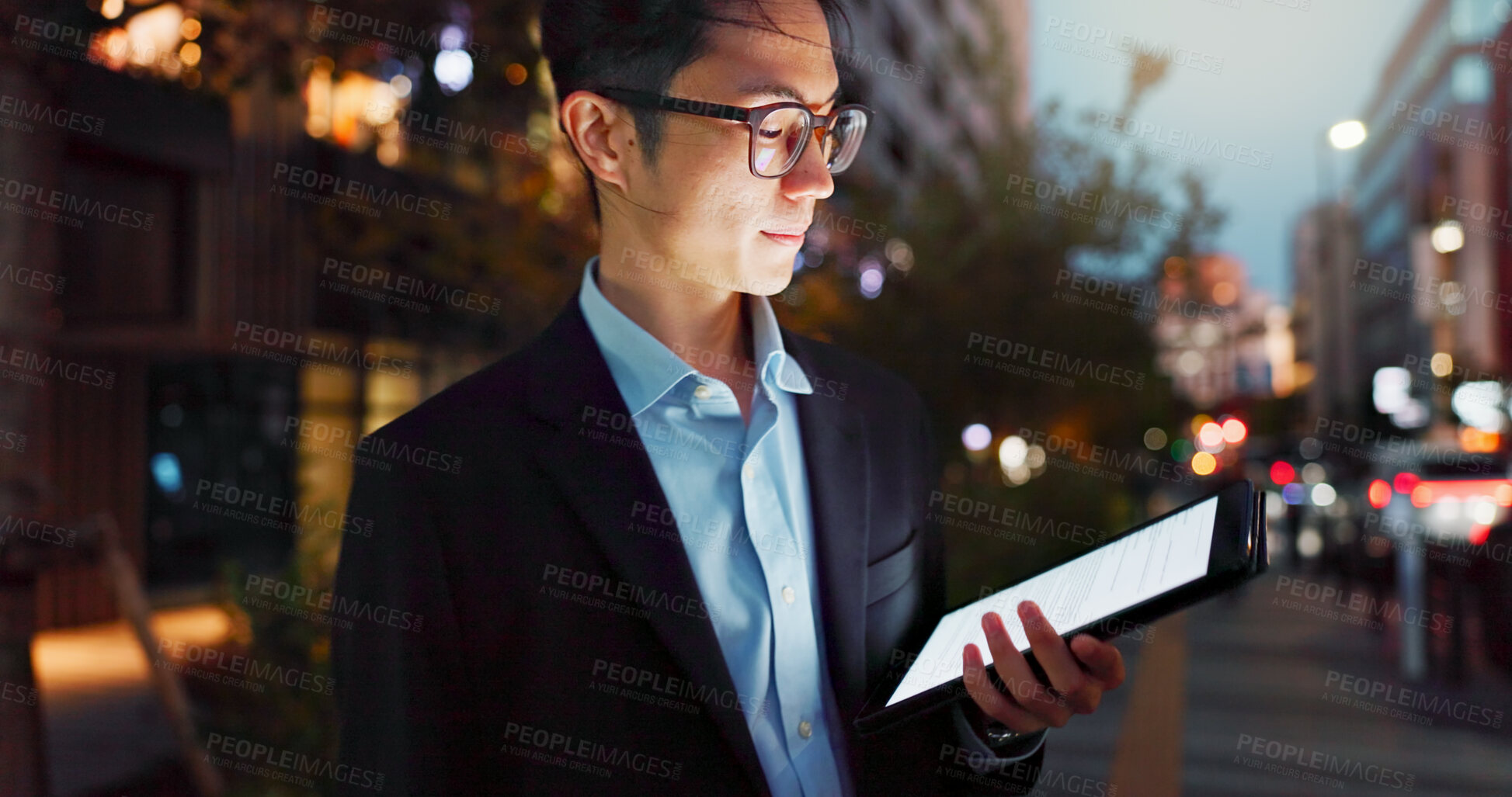 Buy stock photo Tablet, night and Asian businessman in the city reading a blog on a website or internet. Online, glasses and young professional male person networking on digital technology in urban town street.
