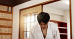 Martial arts students, bow or respect in dojo for aikido practice, discipline or self defense. Black belt, Japanese people learning combat or training workout for fighting class or group education