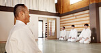 Martial arts students, master or bow in dojo for aikido practice, discipline or self defense in class. Respect, floor or Japanese master teaching combat or training workout for fighting or education