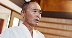 Aikido, master and man in martial arts, class or sensei talking in traditional gym of Japanese technique. Attention, mature fighter and education of self defence, skill or instruction in practice