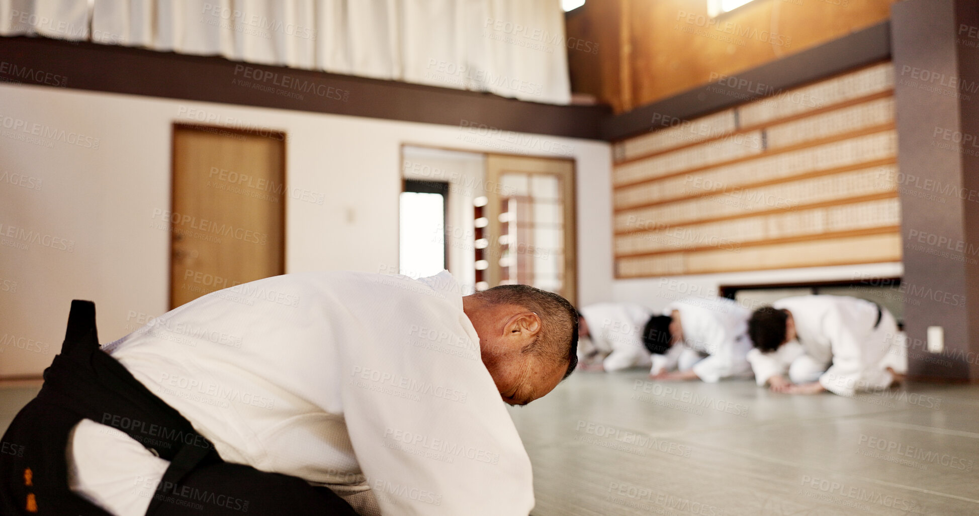 Buy stock photo Aikido, students and bow to master in dojo for martial arts practice, discipline or class in self defense. Japanese, respect and teaching combat in education, training or workout for fighting in club