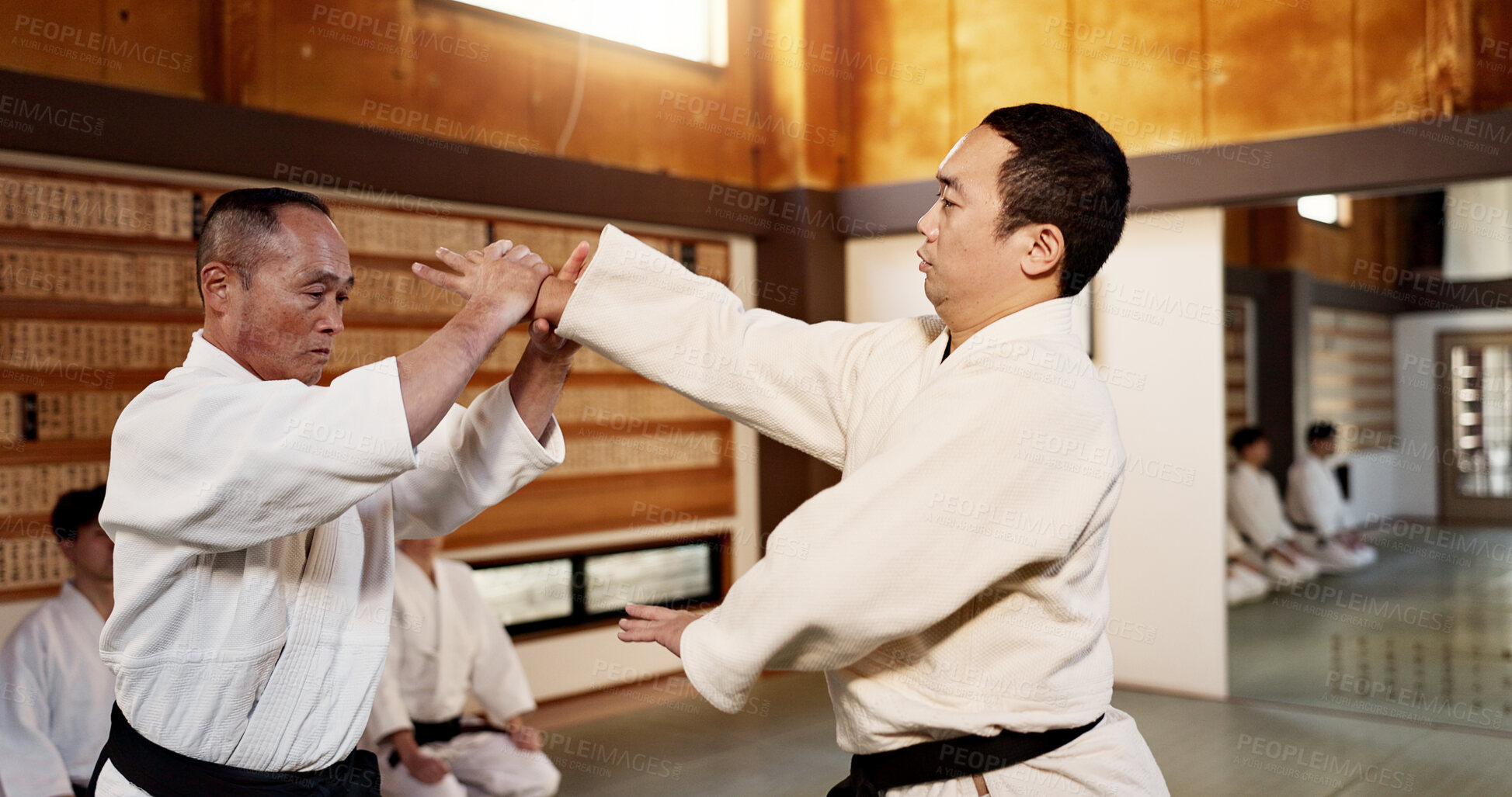 Buy stock photo Japanese master, black belt student and learning martial arts in dojo place in fight and aikido class of self defence. Commitment, battle and fitness in skill, combat and sport discipline in respect