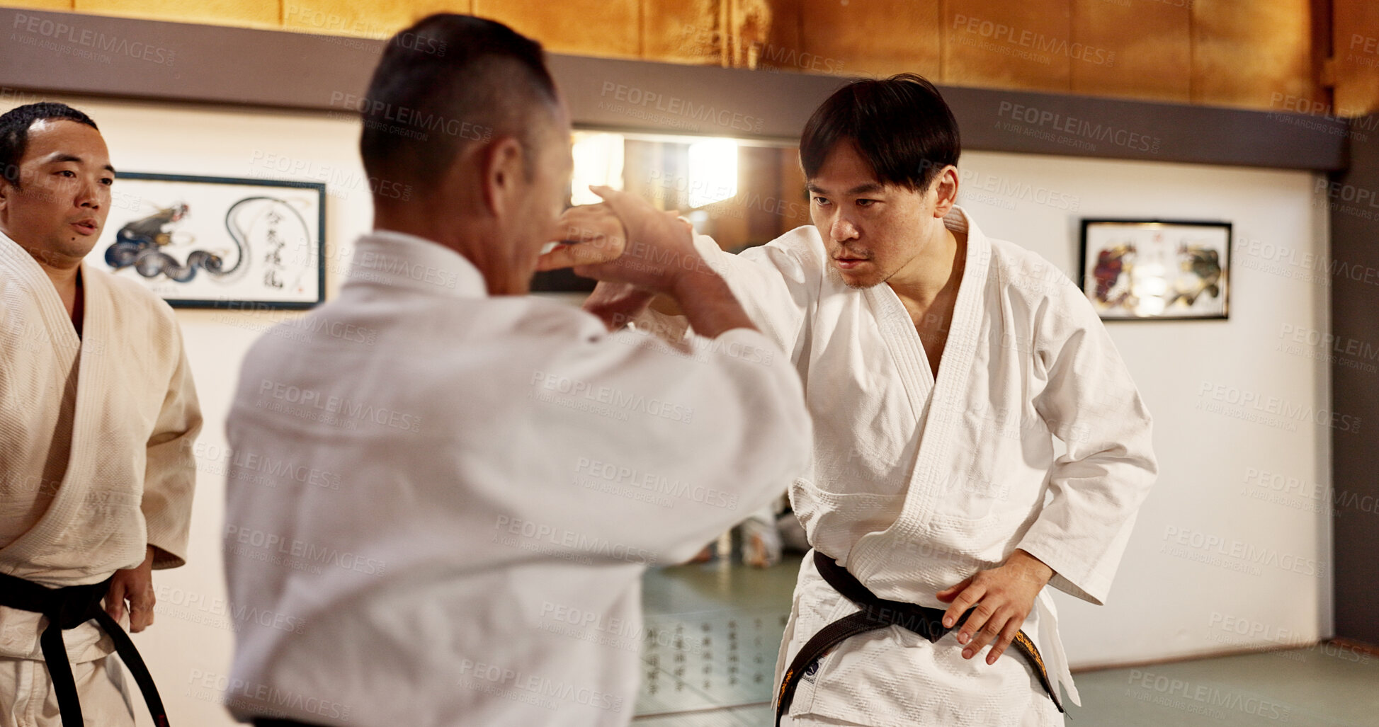 Buy stock photo Japanese master, student or fighting in martial arts in dojo place, block or training in aikido class in self defence. Commitment, battle and fitness in skill, black belt and discipline in respect