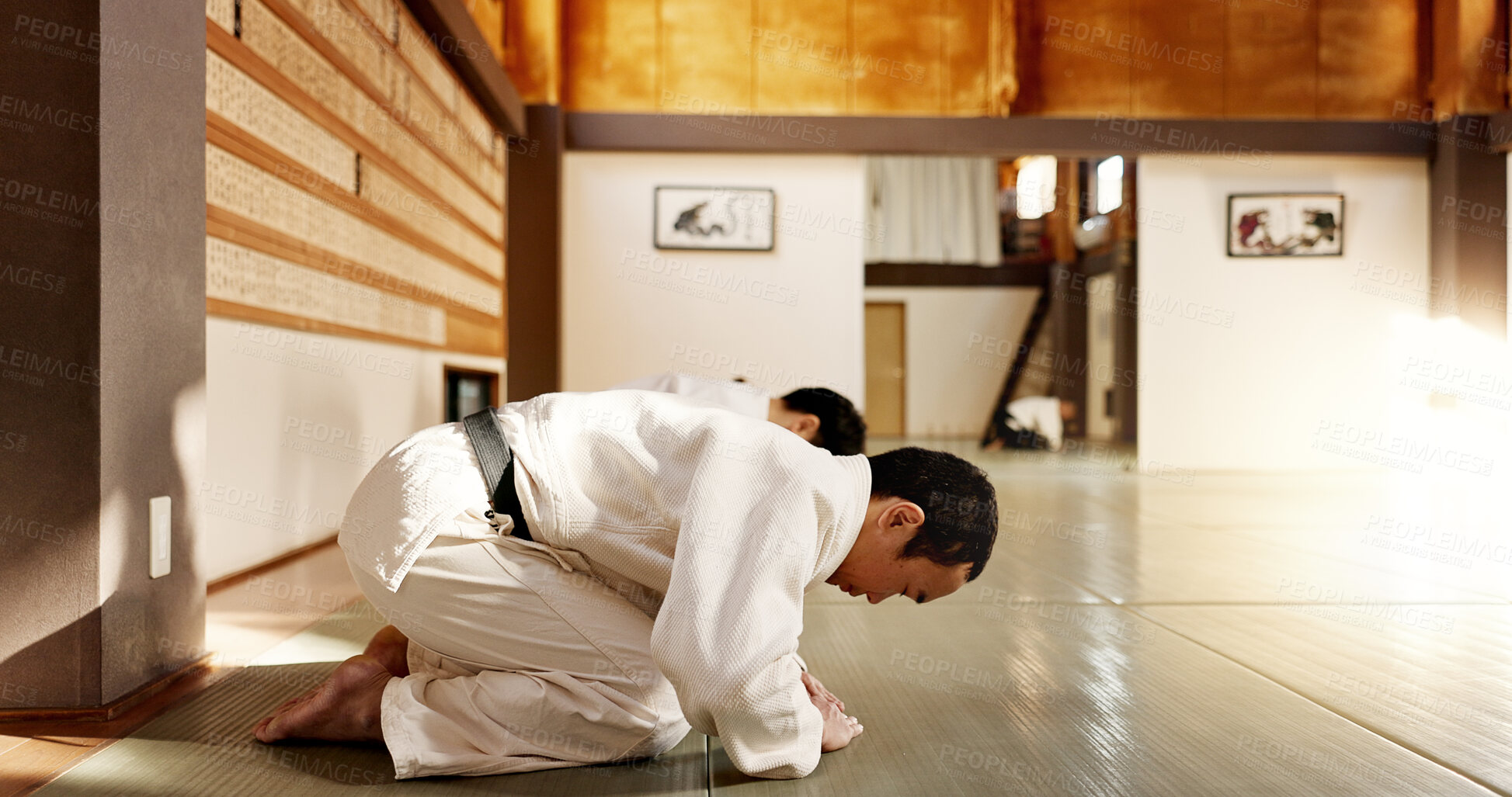Buy stock photo Japanese student, bow or men in dojo to start aikido practice, discipline or self defense education. Black belt master greeting, people learning respect or sensei ready in fighting class or training