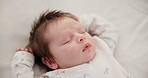 Tired baby, sleeping and nursery bed with morning, nap and dreaming of a young newborn at home. Cozy, sleepy kid and calm with health development from rest and peace in a house with closeup and care