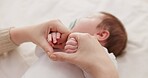 Bed, holding hands and mother with baby, love and support for care, health and wellness at home. Fingers, family or mama with a healthy infant, protection and child development with bond or maternity