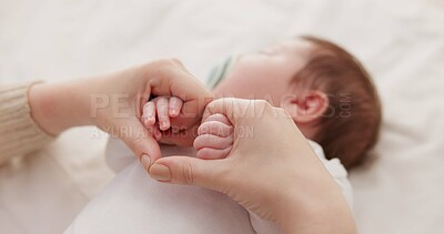 Bed, holding hands and mother with baby, love and support for care, health and wellness at home. Fingers, family or mama with a healthy infant, protection and child development with bond or maternity