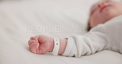 Baby, new born and hand with bracelet on bed for care, trust or support in hospital for birth. Infant, love and hope with child development for future growth in family home, protection and security