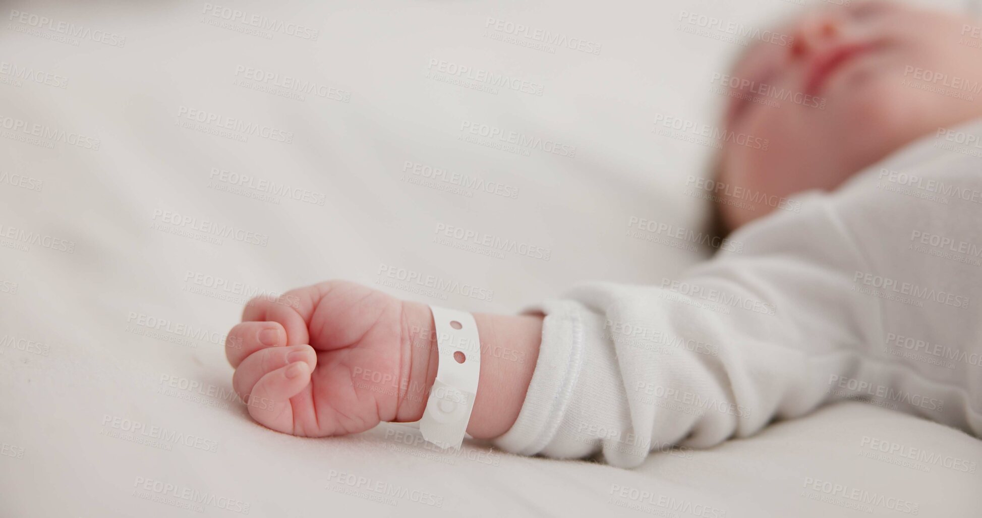 Buy stock photo Baby, new born and hand with bracelet on bed for care, trust or support in hospital for birth. Infant, love and hope with child development for future growth in family home, protection and security