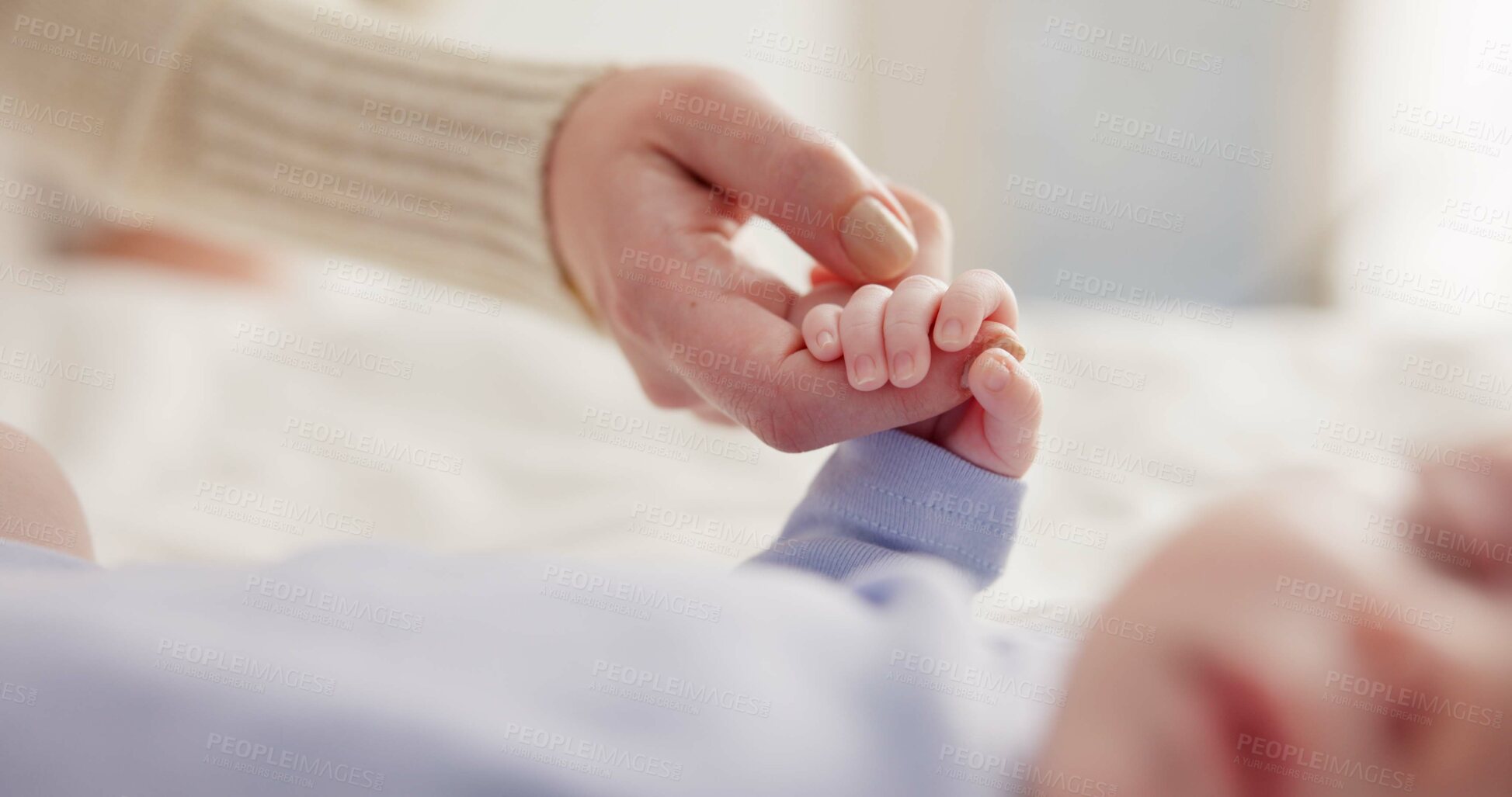 Buy stock photo Parents, family and holding hands with baby on bed for bonding, love and relationship with infant. Adorable, cute and closeup of mom with hand of newborn for support, wellness and protection at home