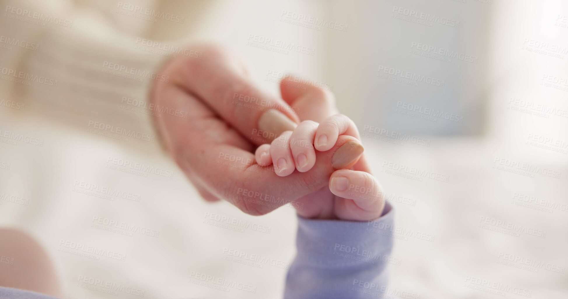 Buy stock photo Sleeping, family and holding hands with baby on bed for bonding, love and relationship with infant. Adorable, care and closeup of parent with newborn for support, dreaming and protection at home
