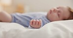 Hand, baby and sleeping on bed in nursery with relaxing, resting and nap on blanket in morning. Newborn, peaceful and dreaming in bedroom of home for child development, growth and nurture or relax