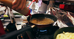 Cooking, sauce and person with pan on gas stove at food market for meal preparation, eating and nutrition. Culinary, restaurant and closeup of utensils to prepare lunch, cuisine dinner and supper