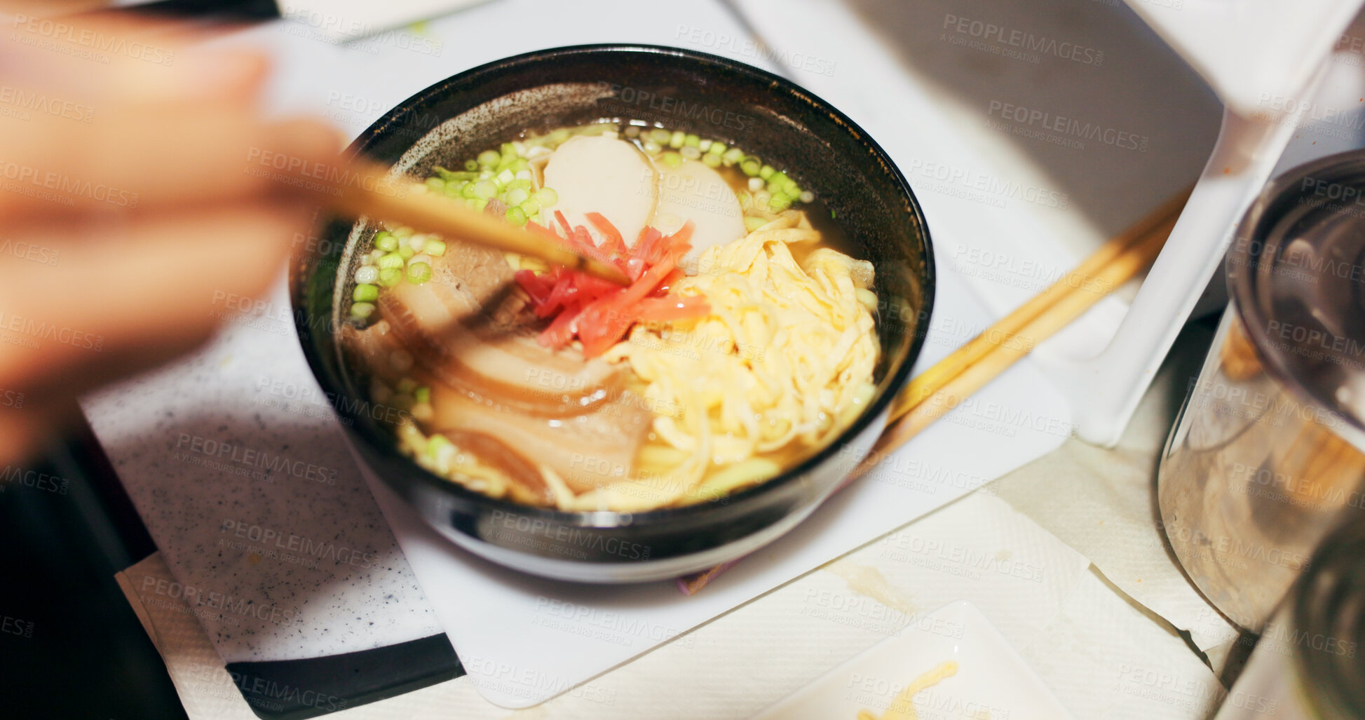 Buy stock photo Ramen food, plate and table in restaurant with person, hands and ginger with closeup for Japanese cuisine. Niboshi bowl, chopsticks and pork for diet, nutrition and catering for wellness in Tokyo