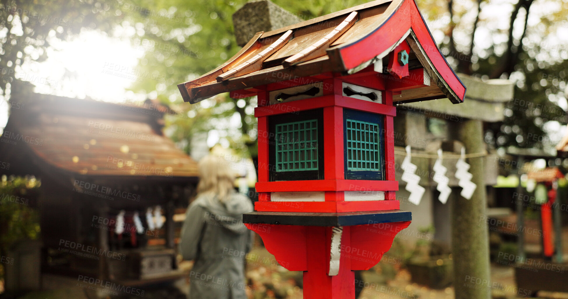 Buy stock photo Japan, nature and wooden lantern in Kyoto with trees, tourist and woman with torii gate. Architecture, japanese culture and shinto shrine in woods with sculpture, religion memorial and monument