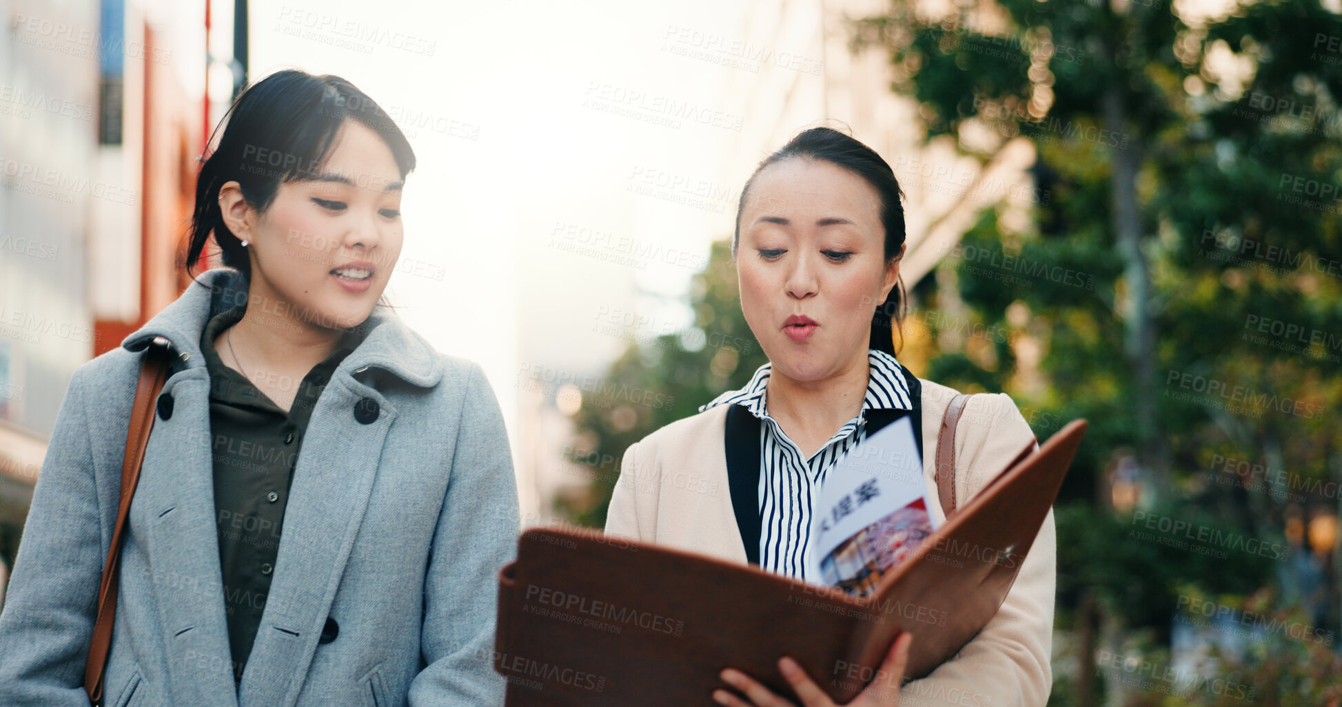 Buy stock photo Talking, walking and Japanese women with a document in the city for business or teamwork on a project. Morning, smile and hr manager in Japan reading a report with an employee for recruitment